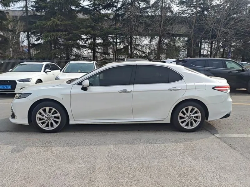 Side profile of a white Toyota Camry reference vehicle